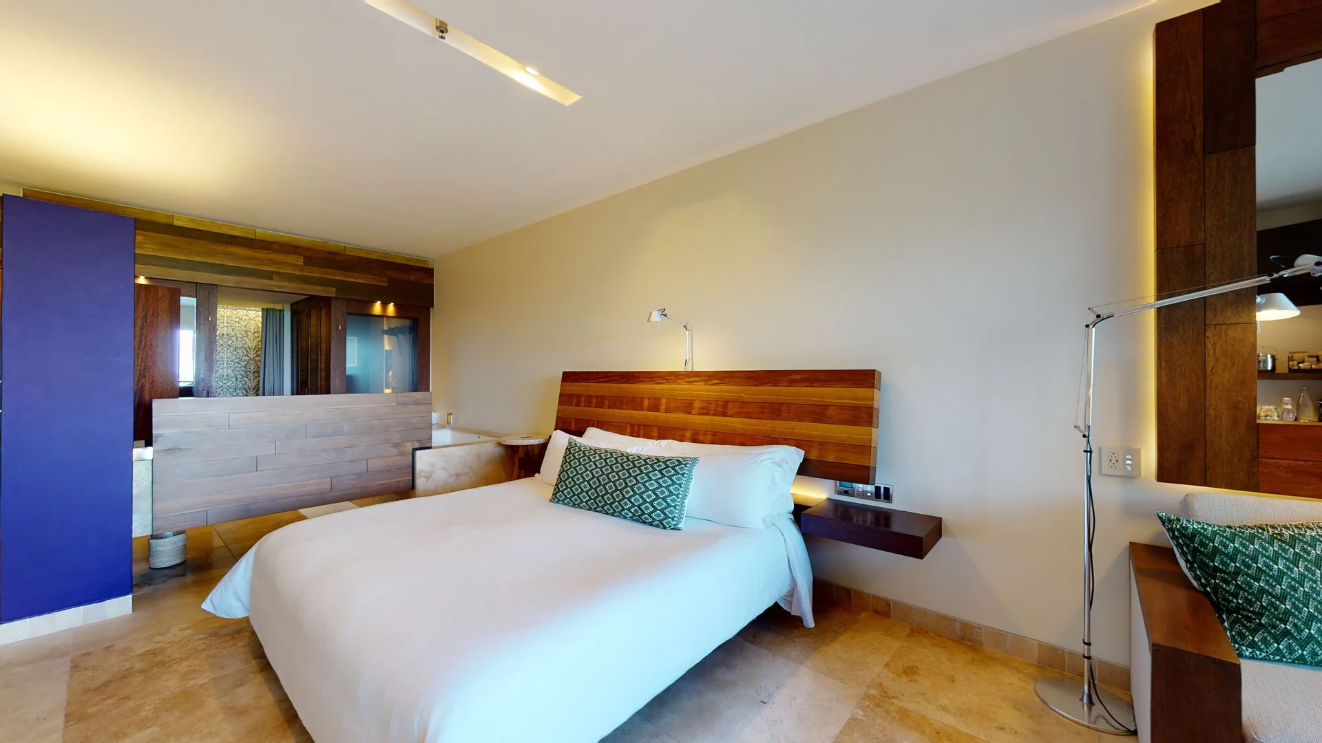 Ocean View Suite bedroom with king bed and open bath area at Hotel Xcaret Arte.