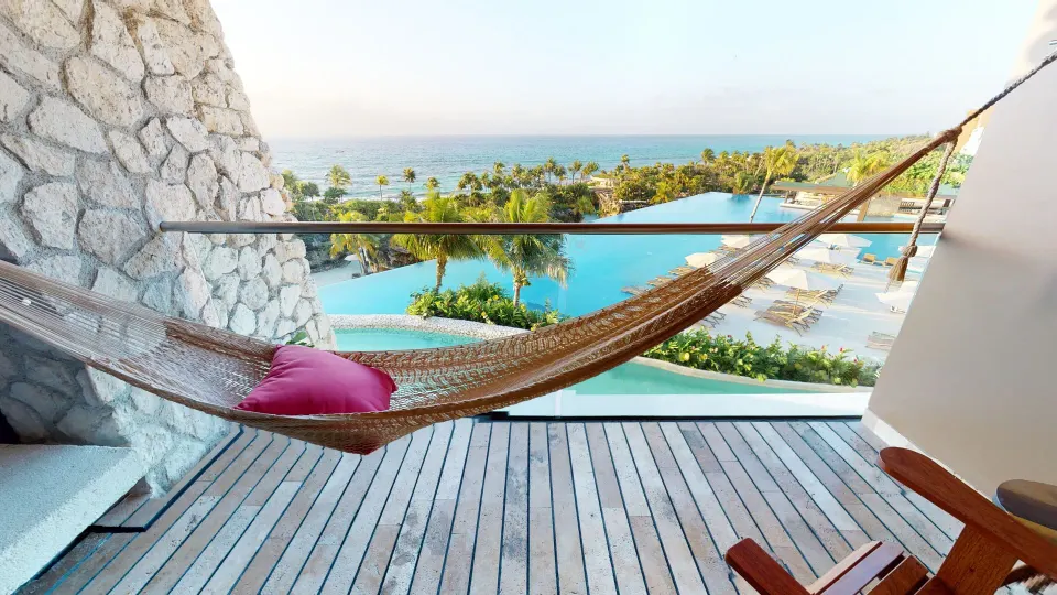 Suite Oceanfront King balcony hammock with ocean and pool views at Hotel Xcaret Arte.
