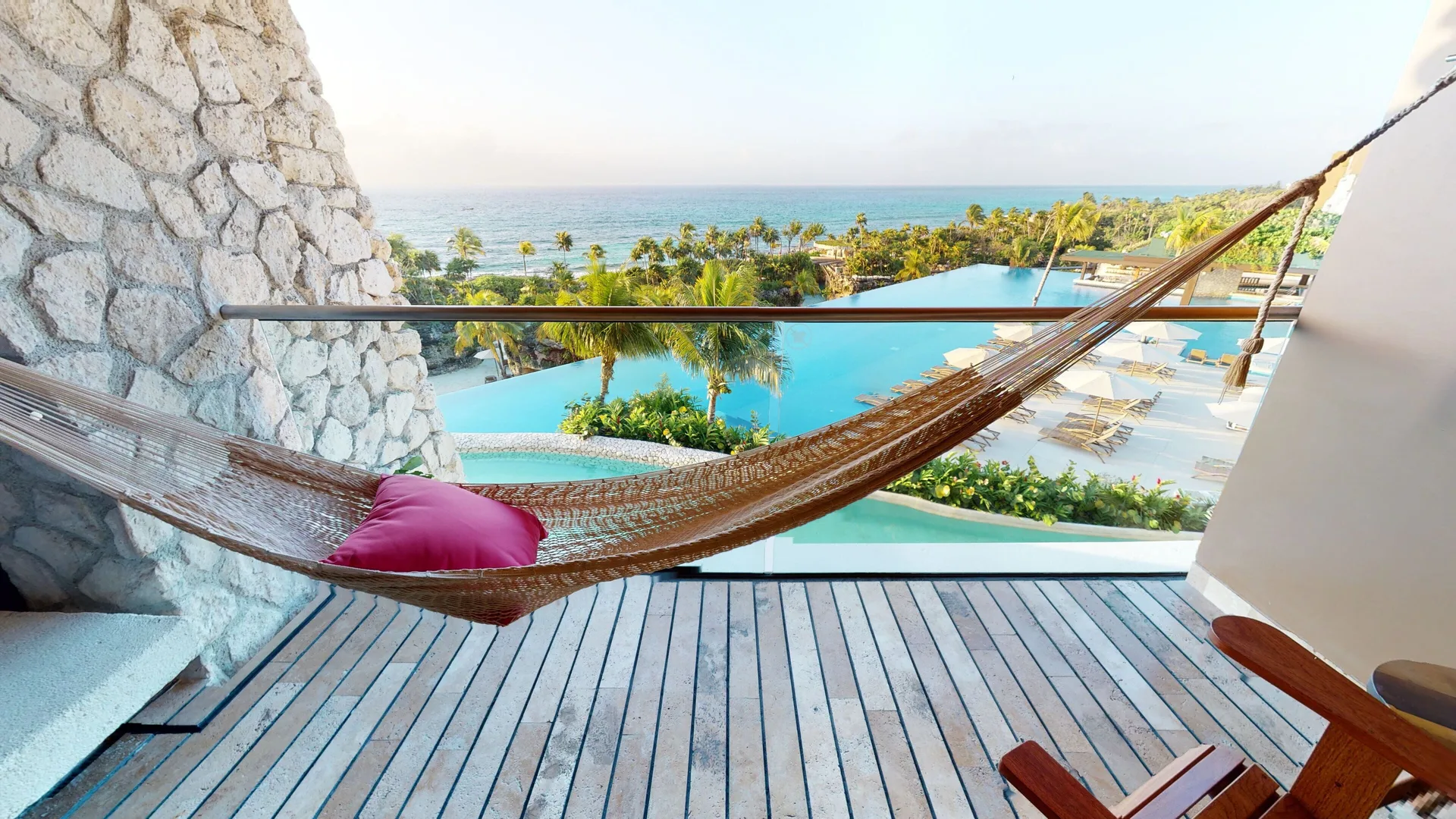 Suite Oceanfront King balcony hammock with ocean and pool views at Hotel Xcaret Arte.