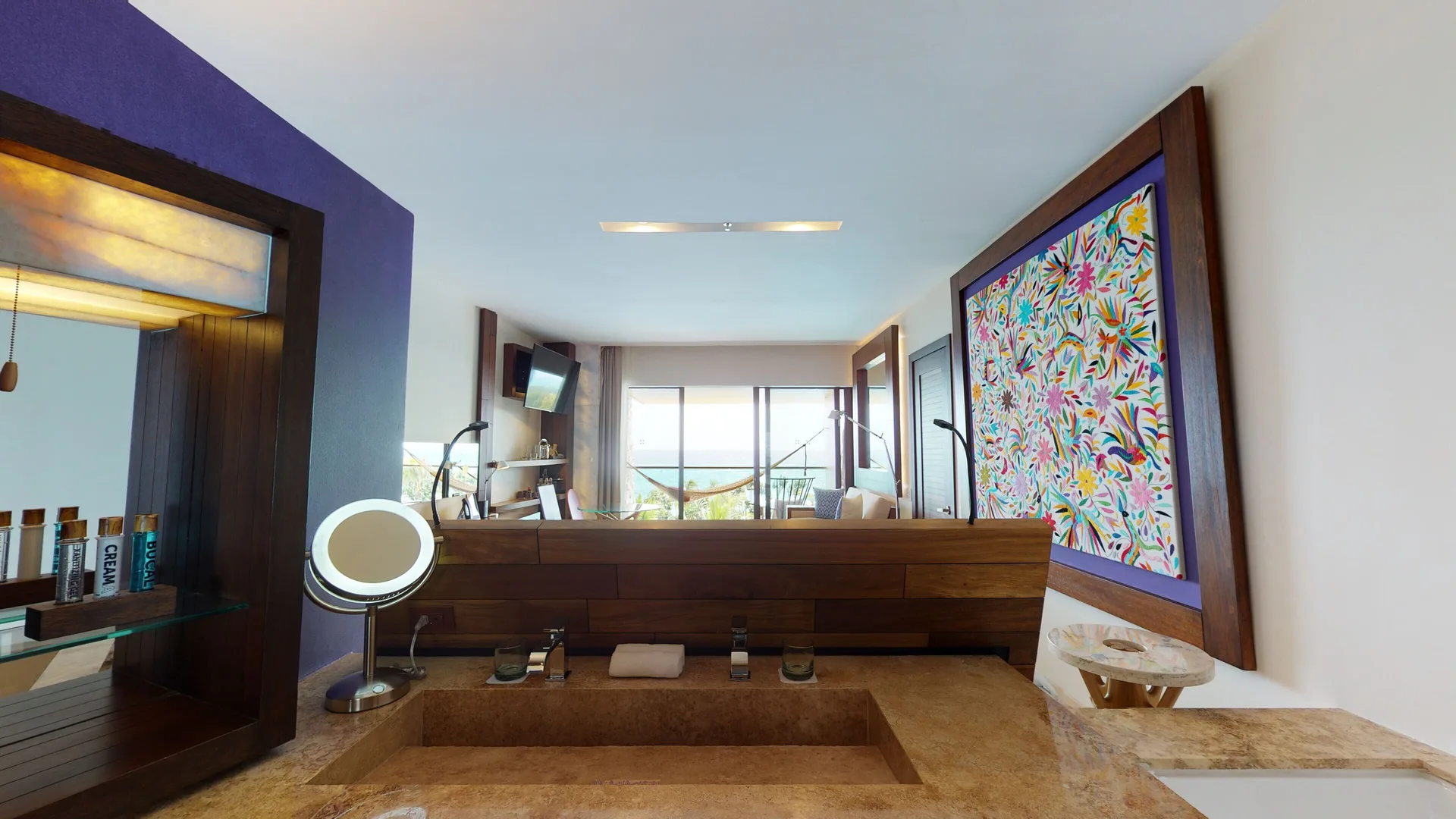 Suite Oceanfront King bathroom with tub and room beyond at Hotel Xcaret Arte.