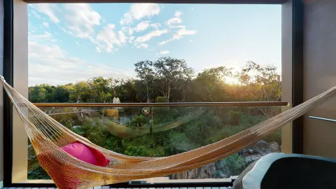 Suite River Spa balcony hammock overlooking greenery at Hotel Xcaret Arte.