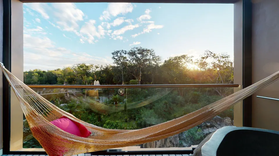 Suite River Spa balcony hammock overlooking greenery at Hotel Xcaret Arte.