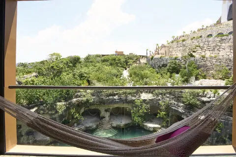 Suite River View Jump Adults balcony hammock overlooking greenery at Hotel Xcaret Arte.