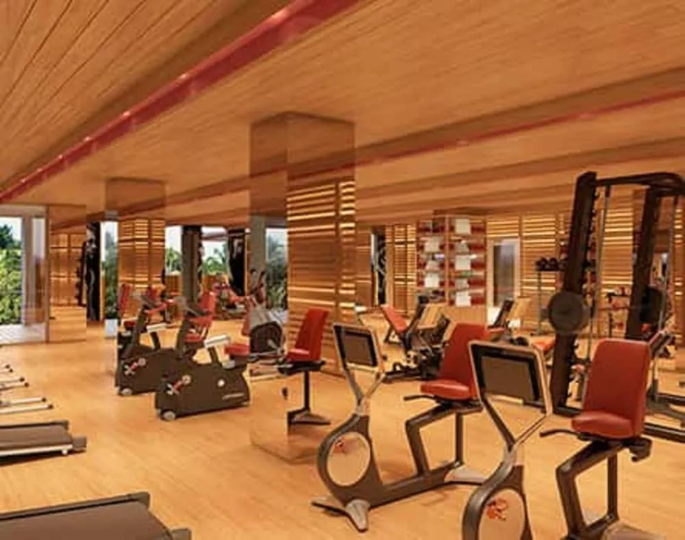 A fitness center with cardio and weight machines at Hotel Xcaret Mexico.