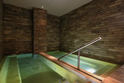 An indoor hydrotherapy pool with tiled walls at Hotel Xcaret Mexico.