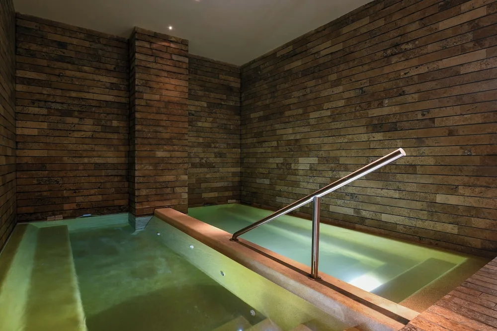 An indoor hydrotherapy pool with tiled walls at Hotel Xcaret Mexico.