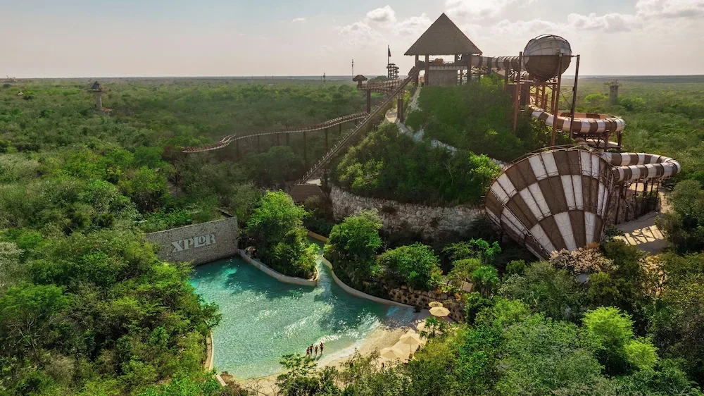Aerial view of nearby adventure park towers and water slide area at Hotel Xcaret Mexico.