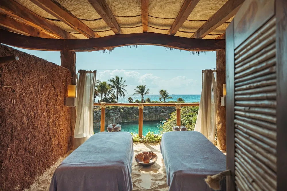 Two spa treatment tables face the Caribbean at Hotel Xcaret Mexico.