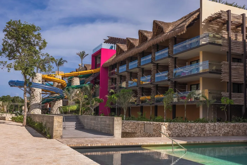 Poolside guest-room building and water slides at Hotel Xcaret Mexico.