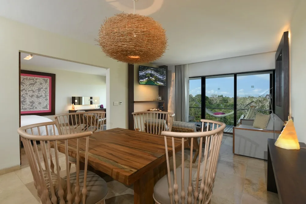 Junior Suite Spa dining and living area with balcony at Hotel Xcaret Mexico.