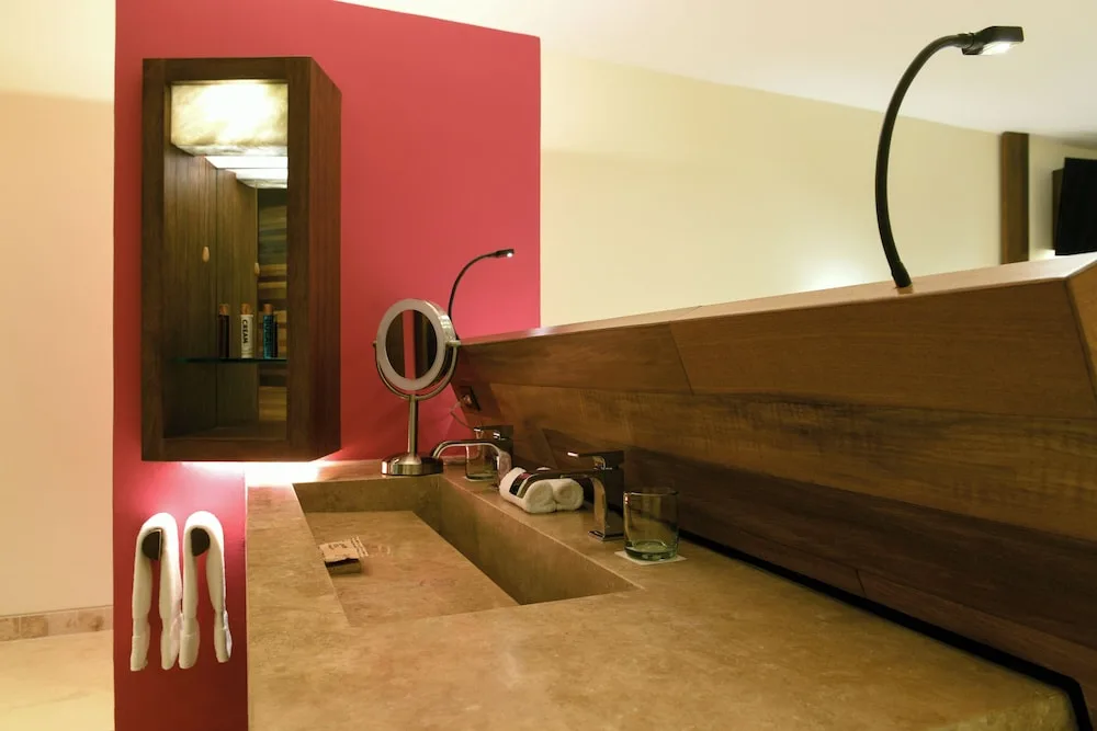 Garden Spa suite bathroom vanity with stone counter at Hotel Xcaret Mexico.