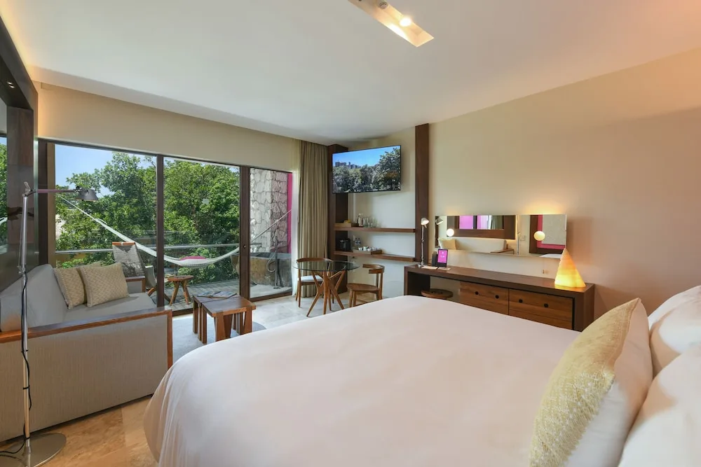 Garden Spa adults-only suite with king bed and balcony hammock at Hotel Xcaret Mexico.
