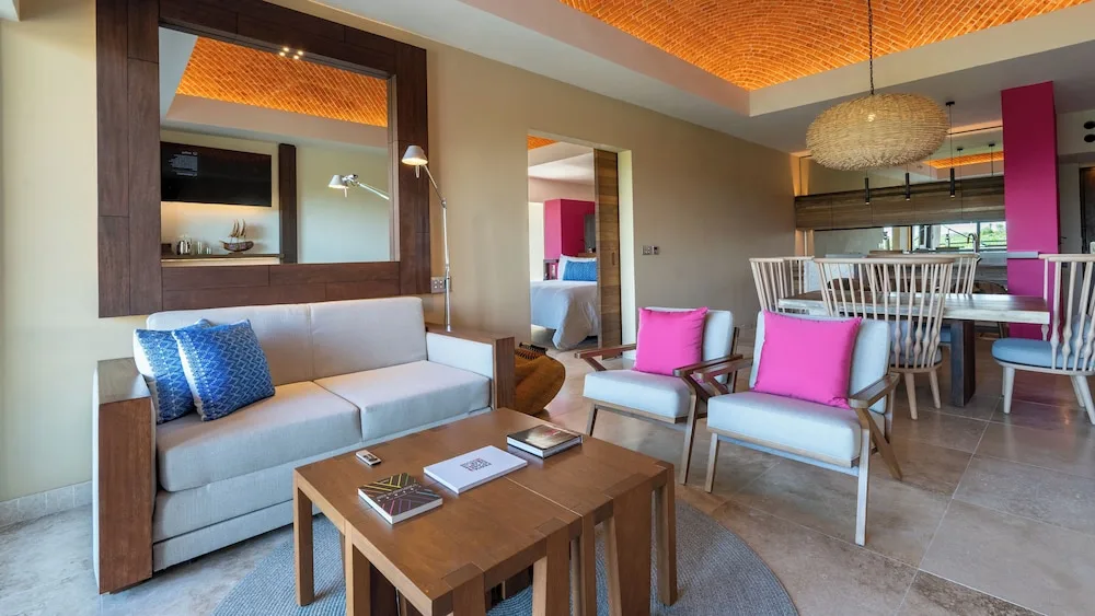Master Suite living area, dining table, and bedroom doorway at Hotel Xcaret Mexico.