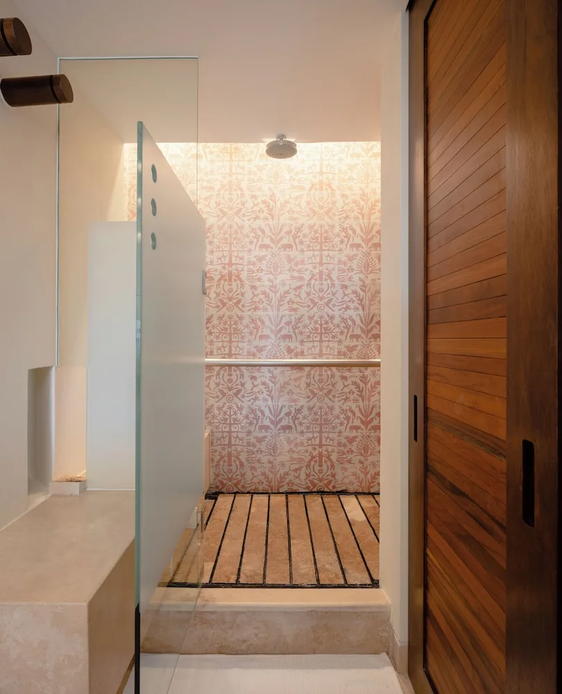 Oceanfront adults-only suite bathroom shower with patterned tile at Hotel Xcaret Mexico.
