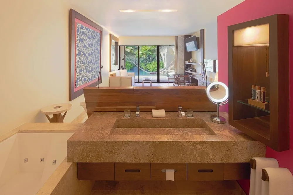 Suite River Jump bathroom vanity and tub with room view at Hotel Xcaret Mexico.