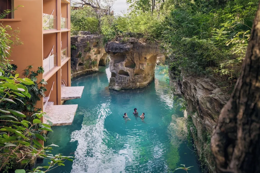 River jump waterway beside suite balconies at Hotel Xcaret Mexico.