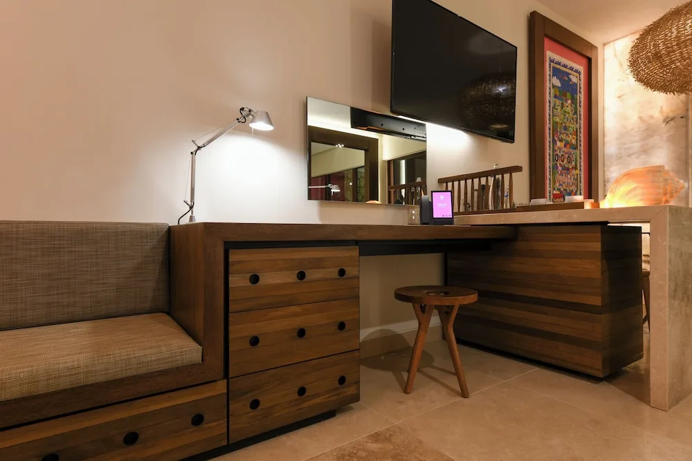 River Spa Suite desk, bench and wall-mounted TV at Hotel Xcaret Mexico.