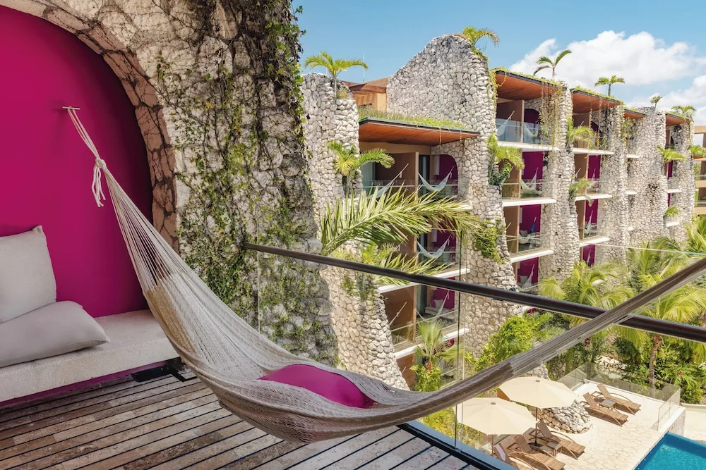 Suite River balcony hammock and stone-front buildings at Hotel Xcaret Mexico.