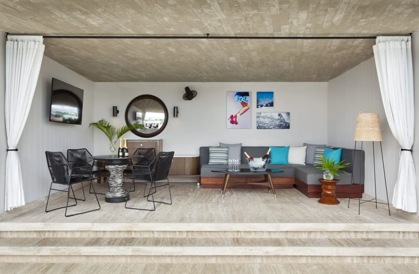 Curtained lounge with sofa and dining table at Hyatt Centric Playa del Carmen - Downtown House & Beach House.