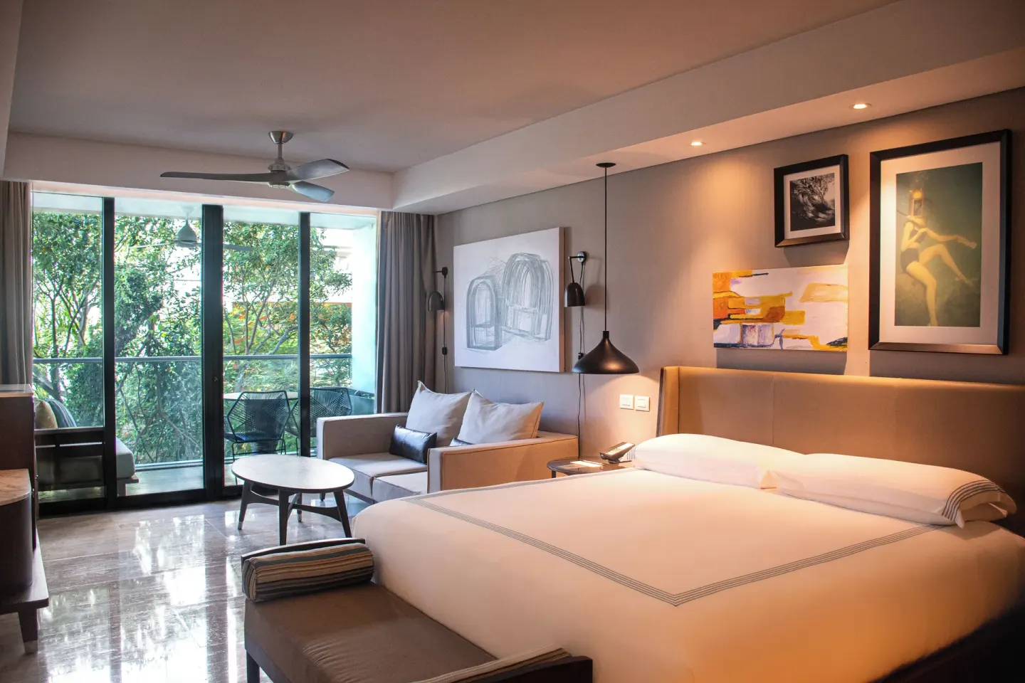 King bed guest room with sofa and balcony trees at Hyatt Centric Playa del Carmen - Downtown House & Beach House.