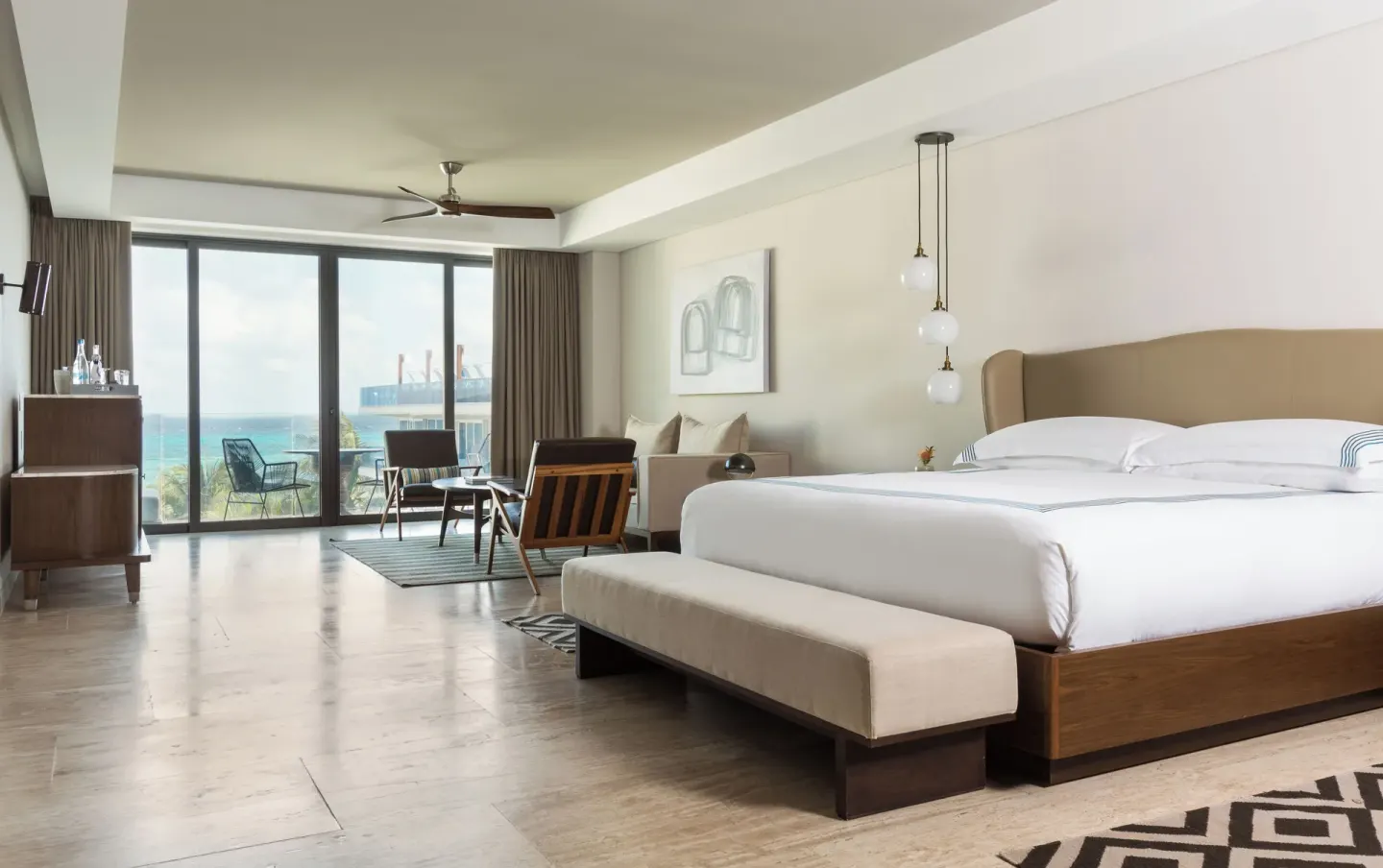 Large king bed guest room with sitting area and ocean view at Hyatt Centric Playa del Carmen - Downtown House & Beach House.
