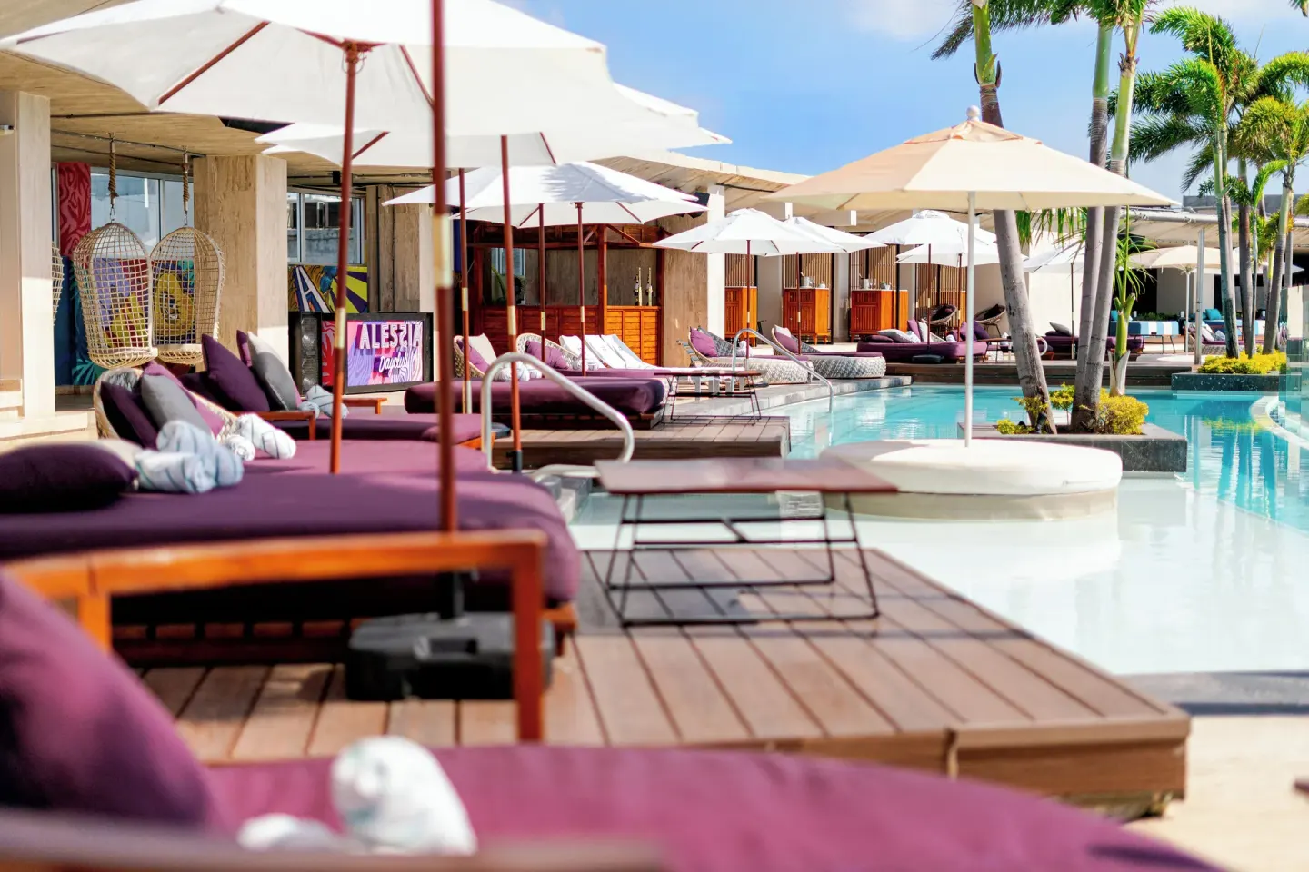 Poolside loungers and umbrellas at Hyatt Centric Playa del Carmen - Downtown House & Beach House.