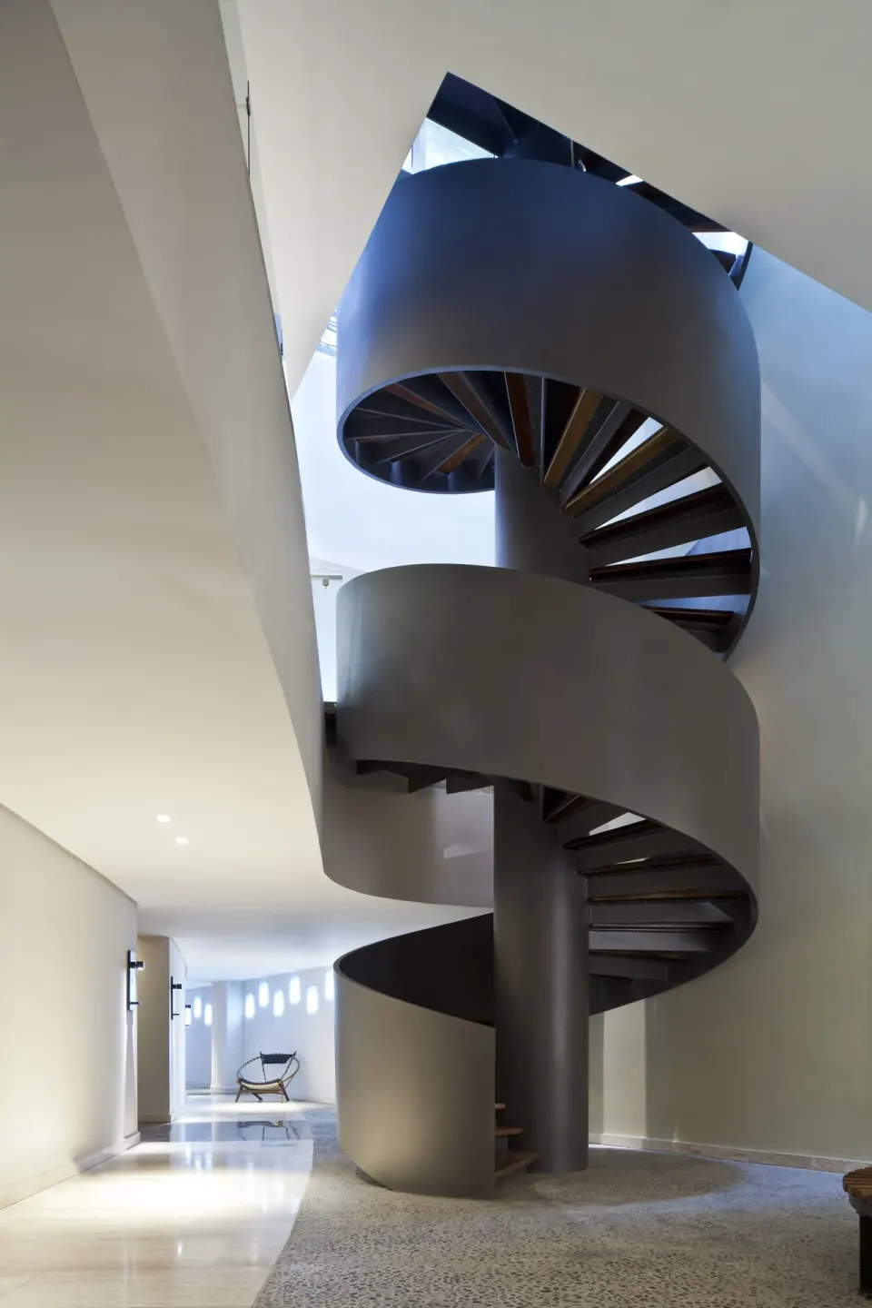 Spiral staircase in a modern interior at Hyatt Centric Playa del Carmen - Downtown House & Beach House.