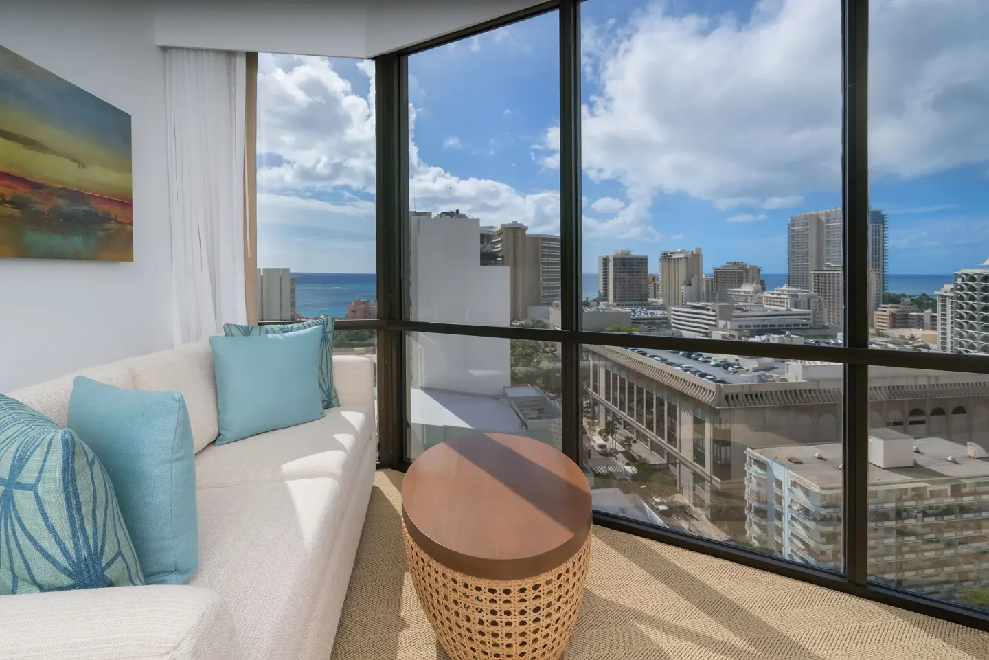 Corner sitting area with ocean and city views at Hyatt Centric Waikiki Beach.