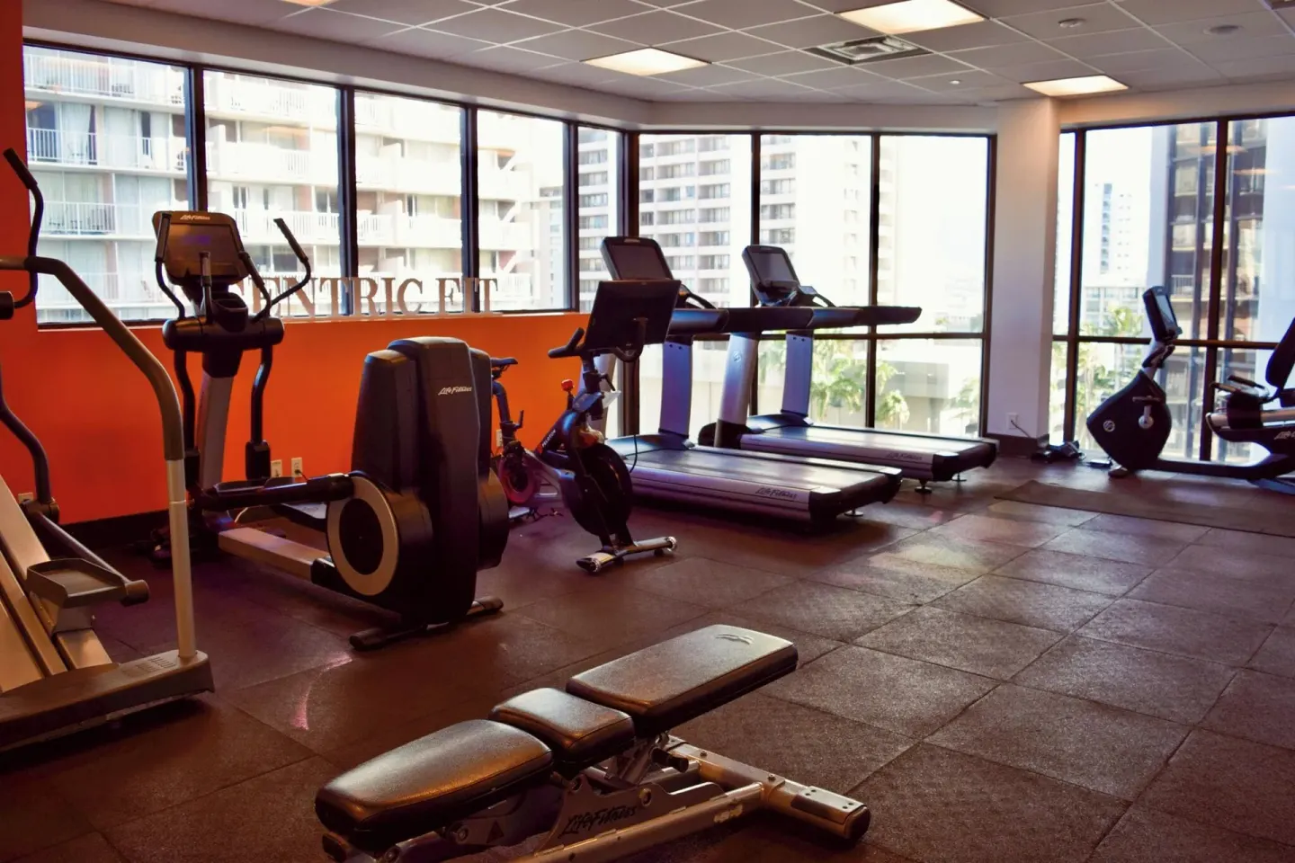 Fitness room with treadmills, bikes, and weight bench at Hyatt Centric Waikiki Beach.