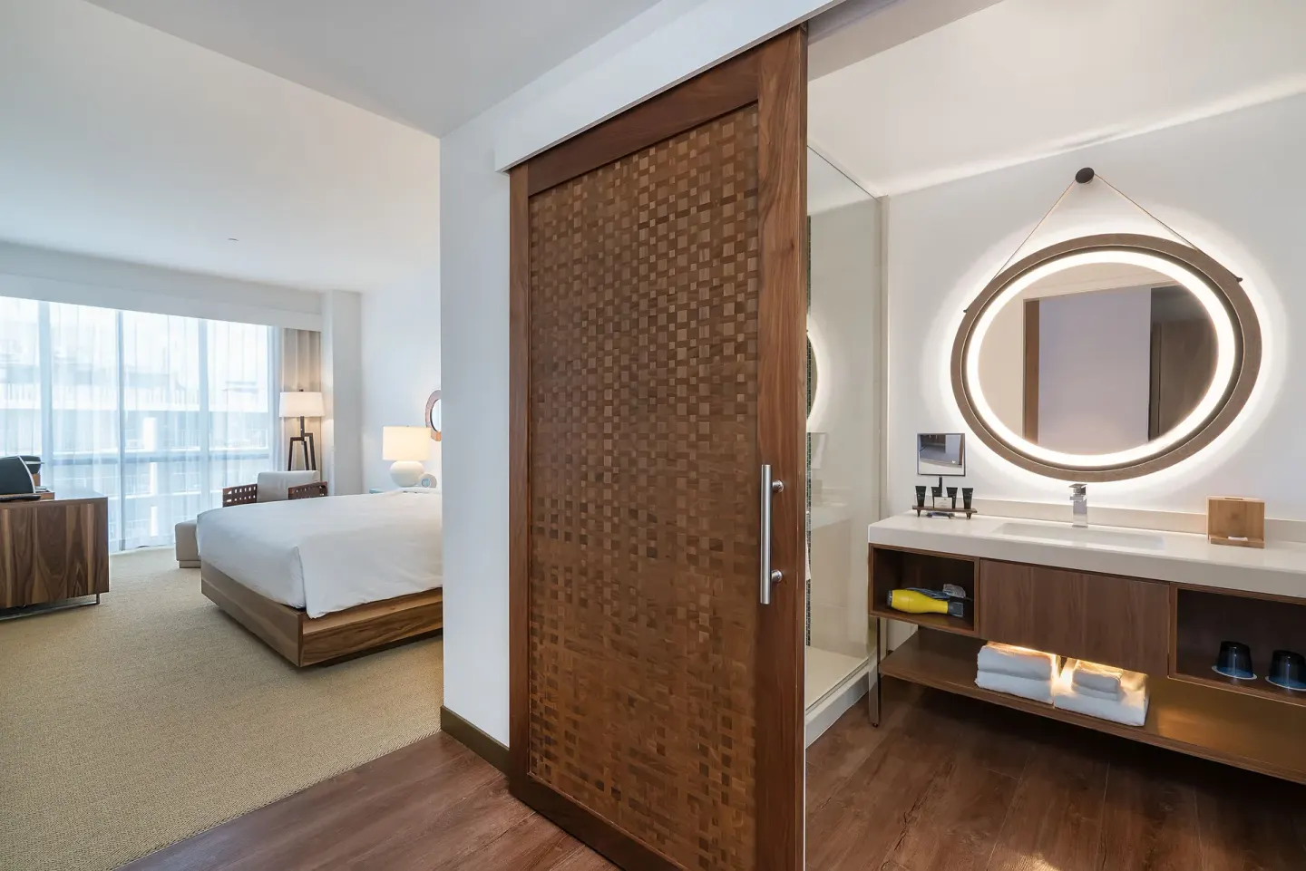 Guest room vanity and adjacent king bed at Hyatt Centric Waikiki Beach.