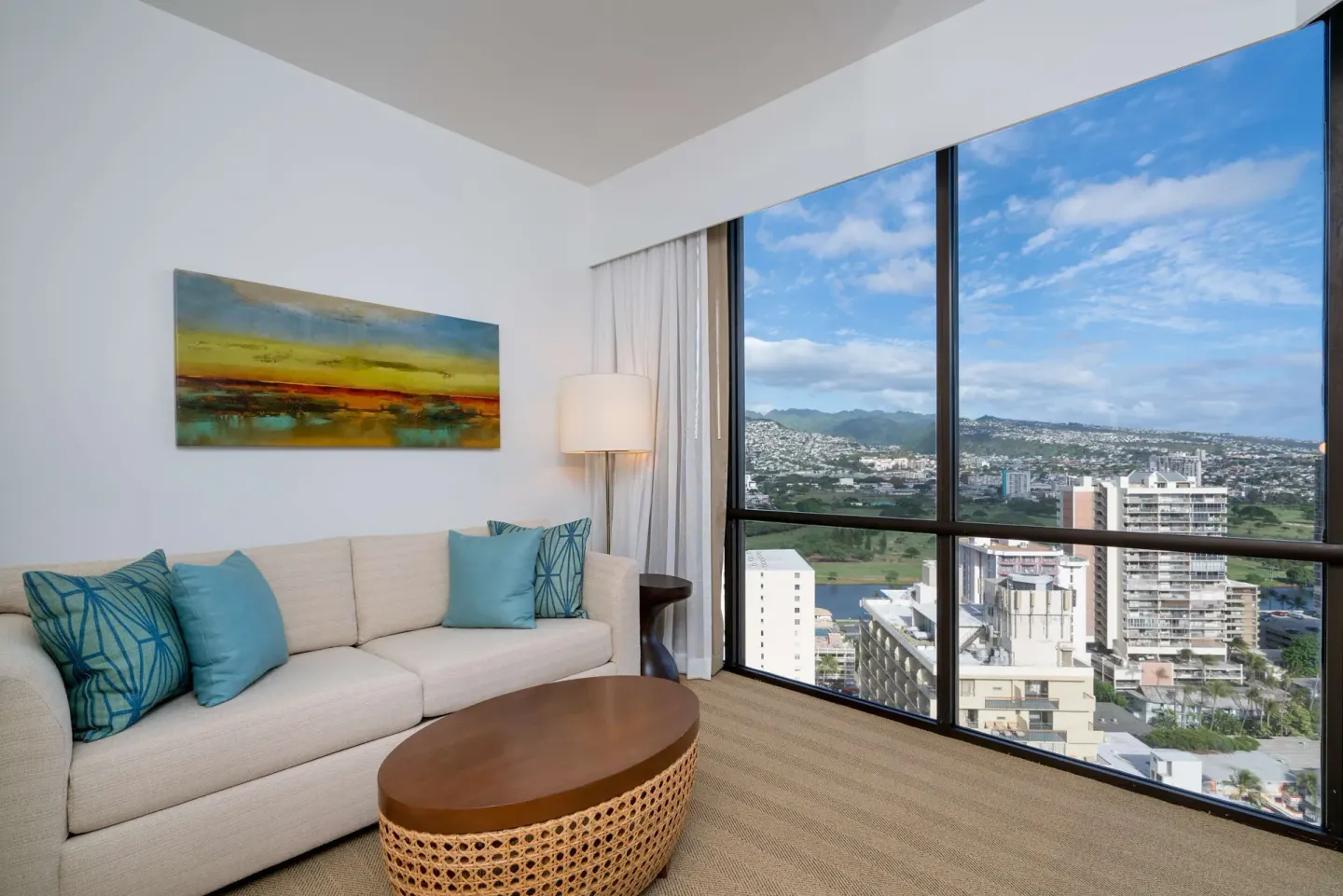Sofa sitting area with mountain and city views at Hyatt Centric Waikiki Beach.