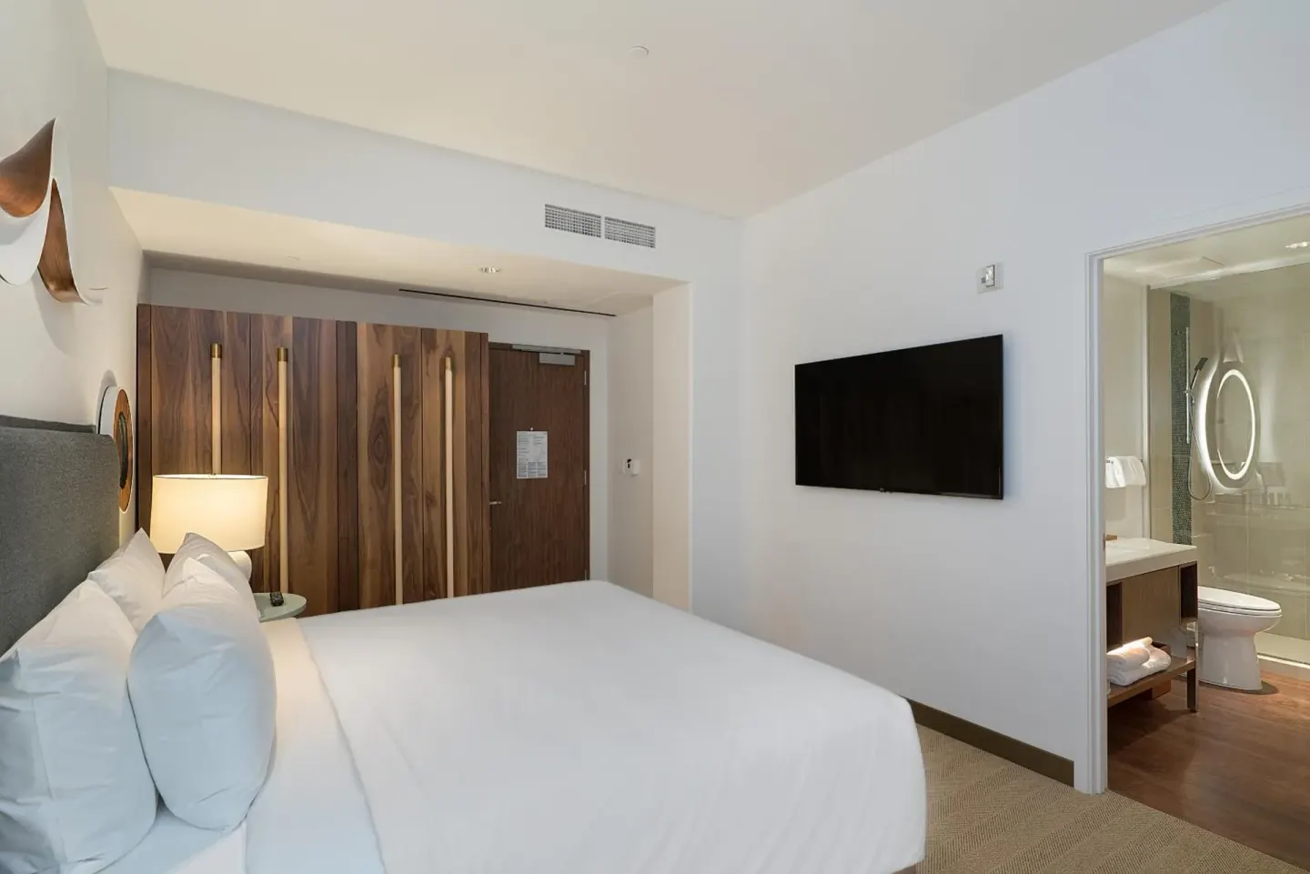 High floor king room with wall TV and open bathroom at Hyatt Centric Waikiki Beach.