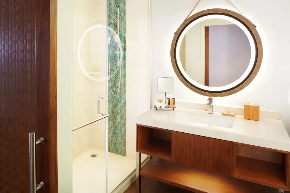 Bathroom vanity and shower in an ocean view room at Hyatt Centric Waikiki Beach.