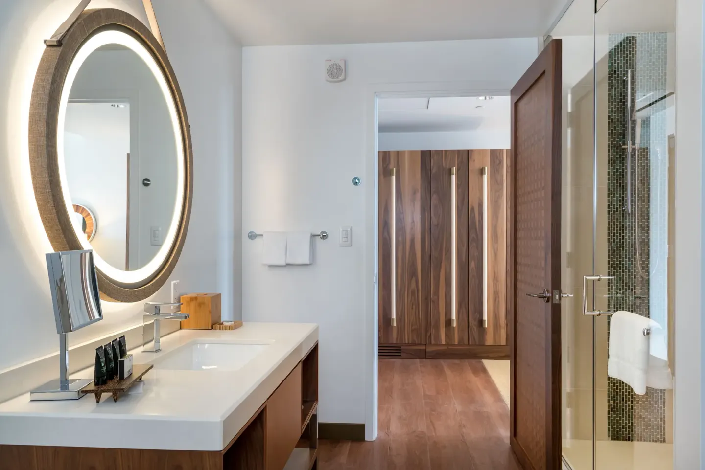 Guest room bathroom vanity and glass shower at Hyatt Centric Waikiki Beach.