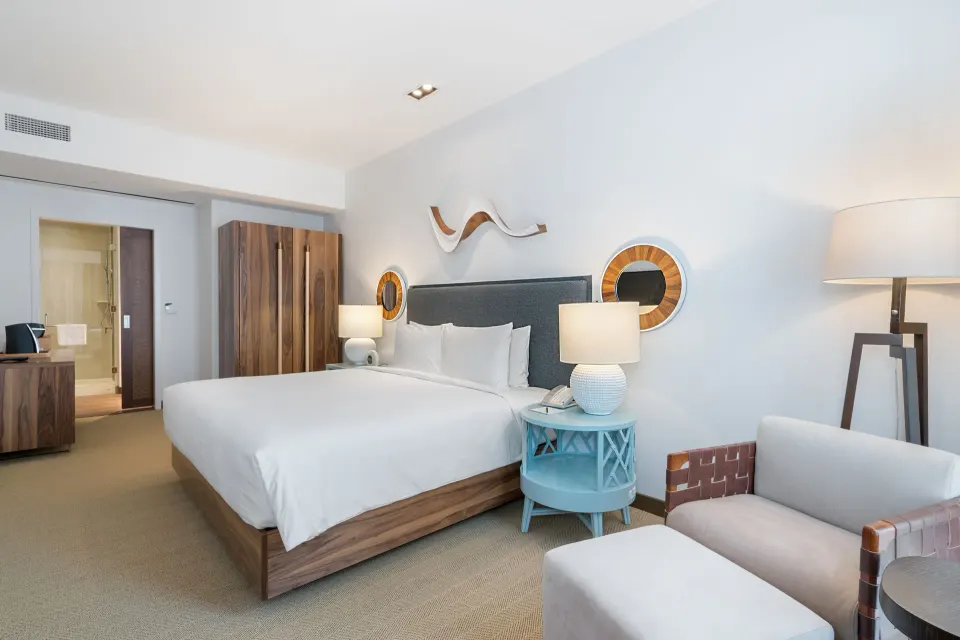 King bed guest room with seating at Hyatt Centric Waikiki Beach.