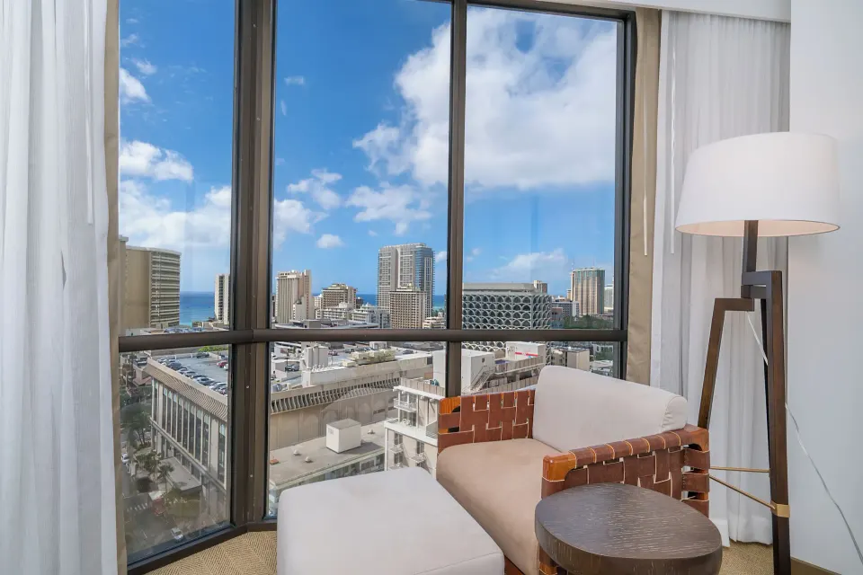 Guest room seating nook with city and ocean view at Hyatt Centric Waikiki Beach.