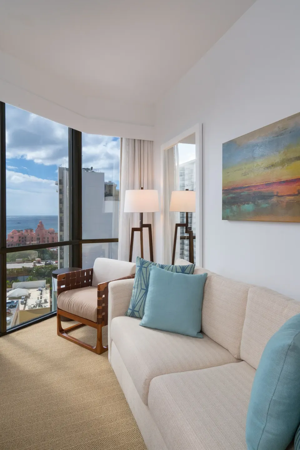 Ocean View Suite sitting area with corner windows and ocean view at Hyatt Centric Waikiki Beach.