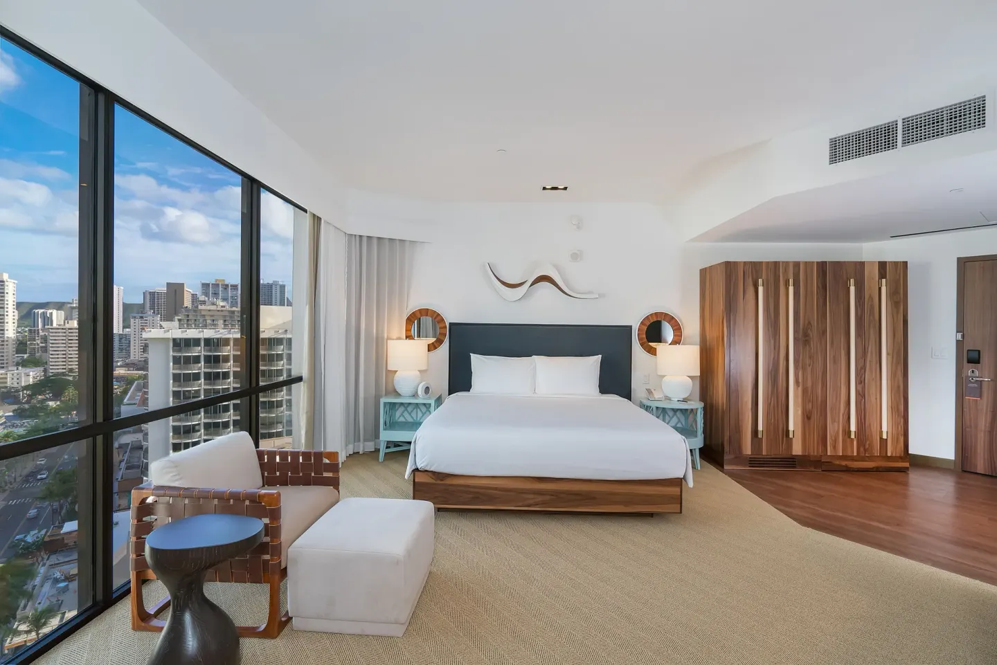 Mountain view suite bedroom with king bed and city windows at Hyatt Centric Waikiki Beach.