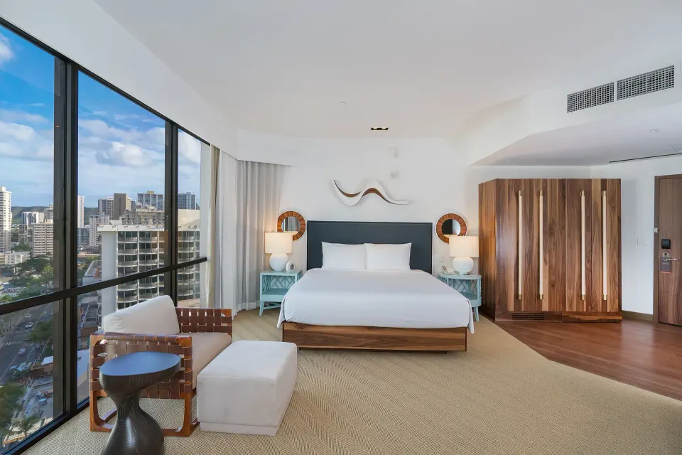Mountain view suite bedroom with king bed and city windows at Hyatt Centric Waikiki Beach.
