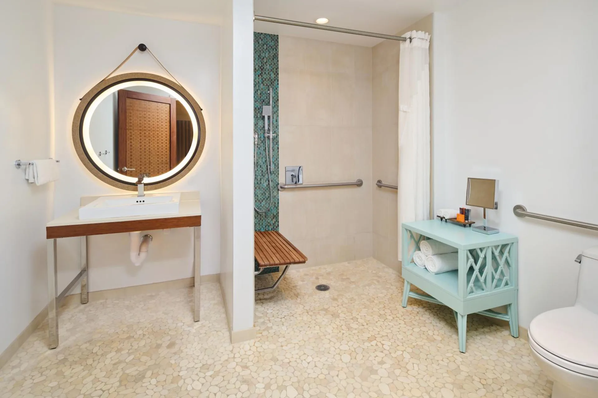 Accessible bathroom with roll-in shower at Hyatt Centric Waikiki Beach featuring modern fixtures and accessibility features in Honolulu.