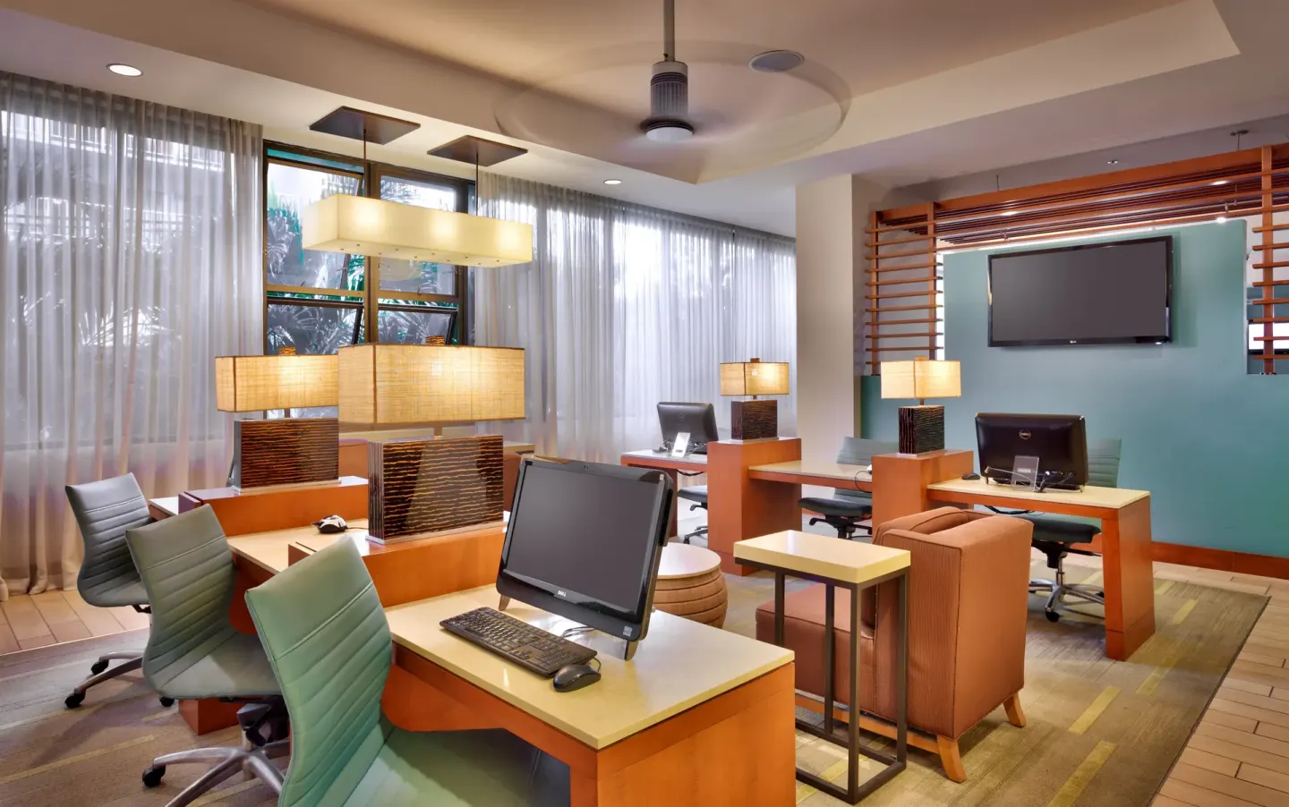Business center with computers and work desks at Hyatt Place Waikiki Beach.