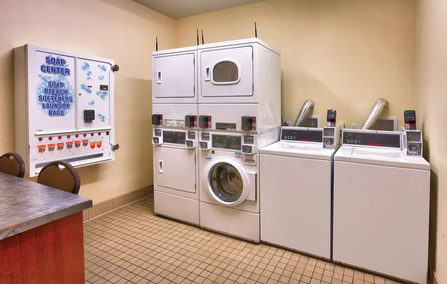 Guest laundry room with washers, dryers, and soap dispenser at Hyatt Place Waikiki Beach.