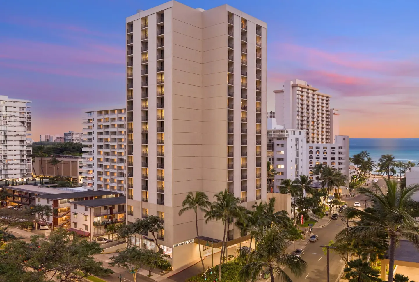 Hotel tower near Waikiki shoreline at sunset at Hyatt Place Waikiki Beach.