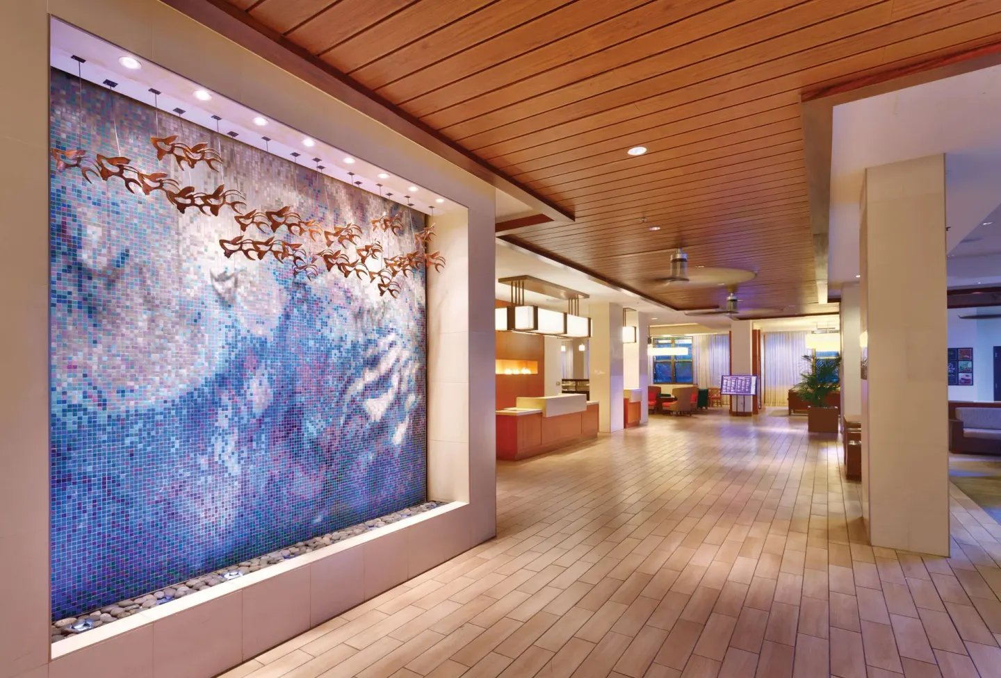 Lobby corridor with mosaic wave wall at Hyatt Place Waikiki Beach.