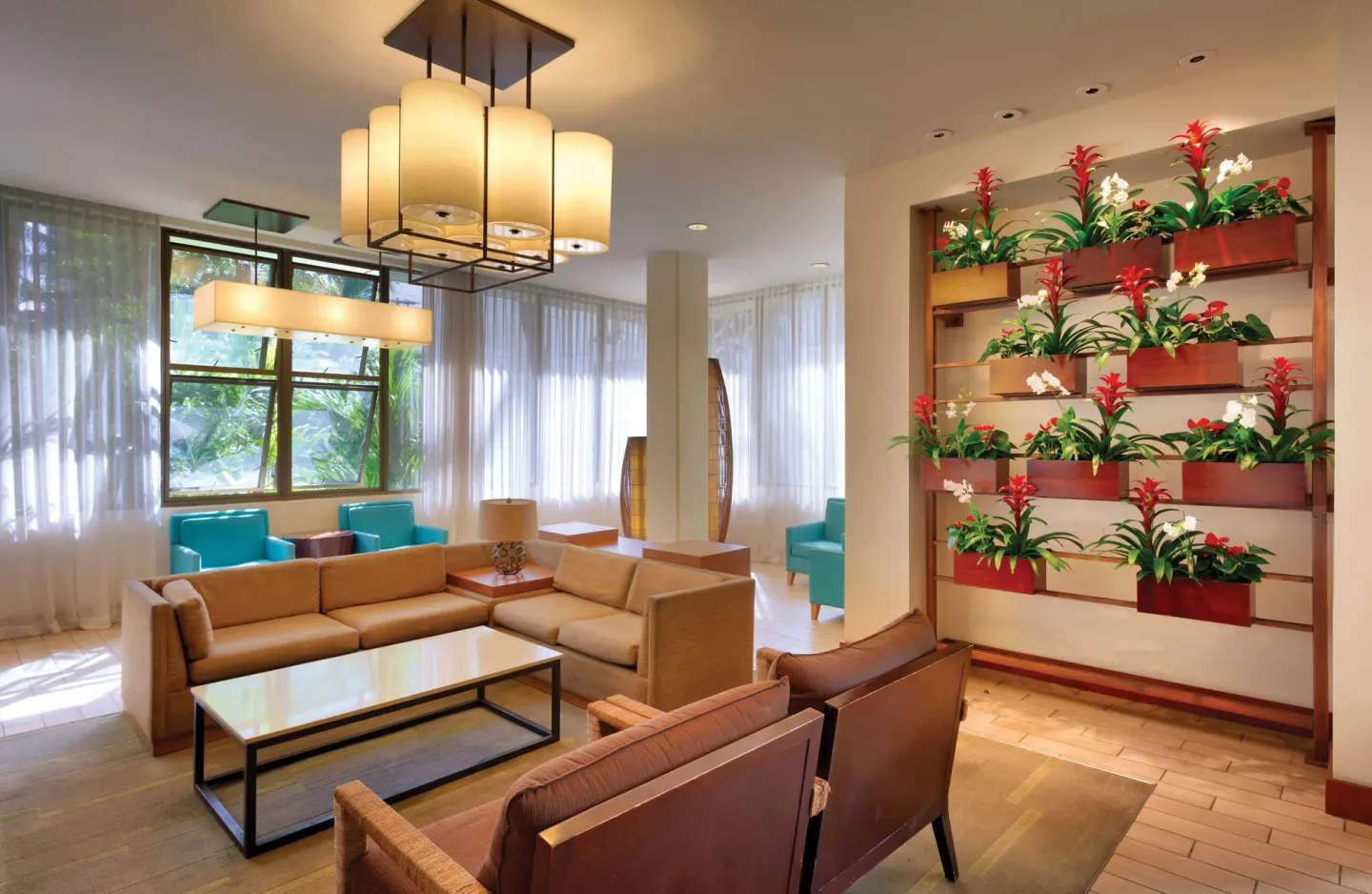 Lobby seating with floral wall display at Hyatt Place Waikiki Beach.