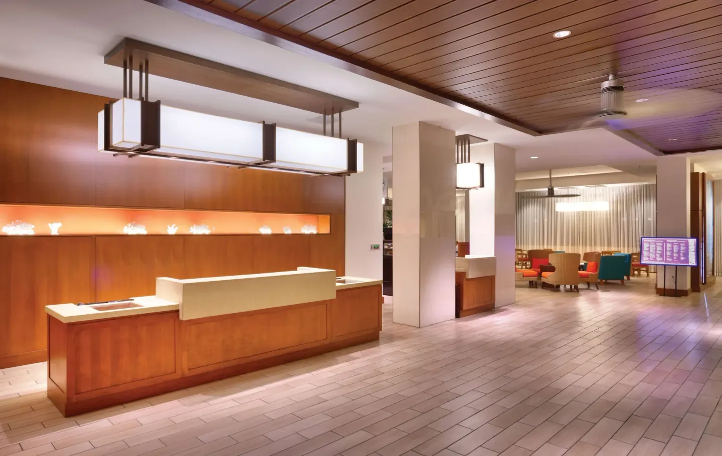 Reception desk and open lobby seating area at Hyatt Place Waikiki Beach.
