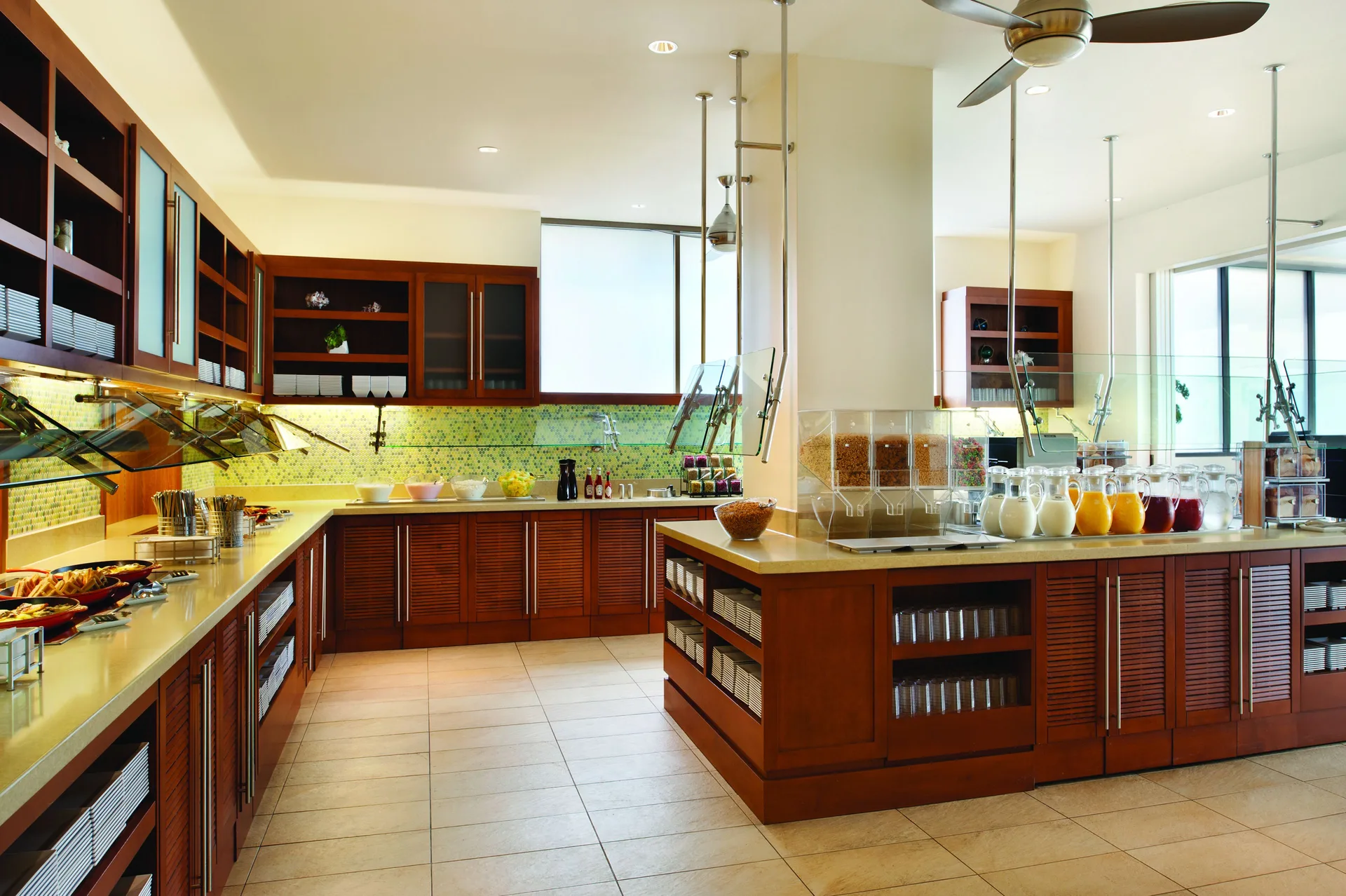Breakfast buffet counter with juices, cereal, and serving stations at Hyatt Place Waikiki Beach.