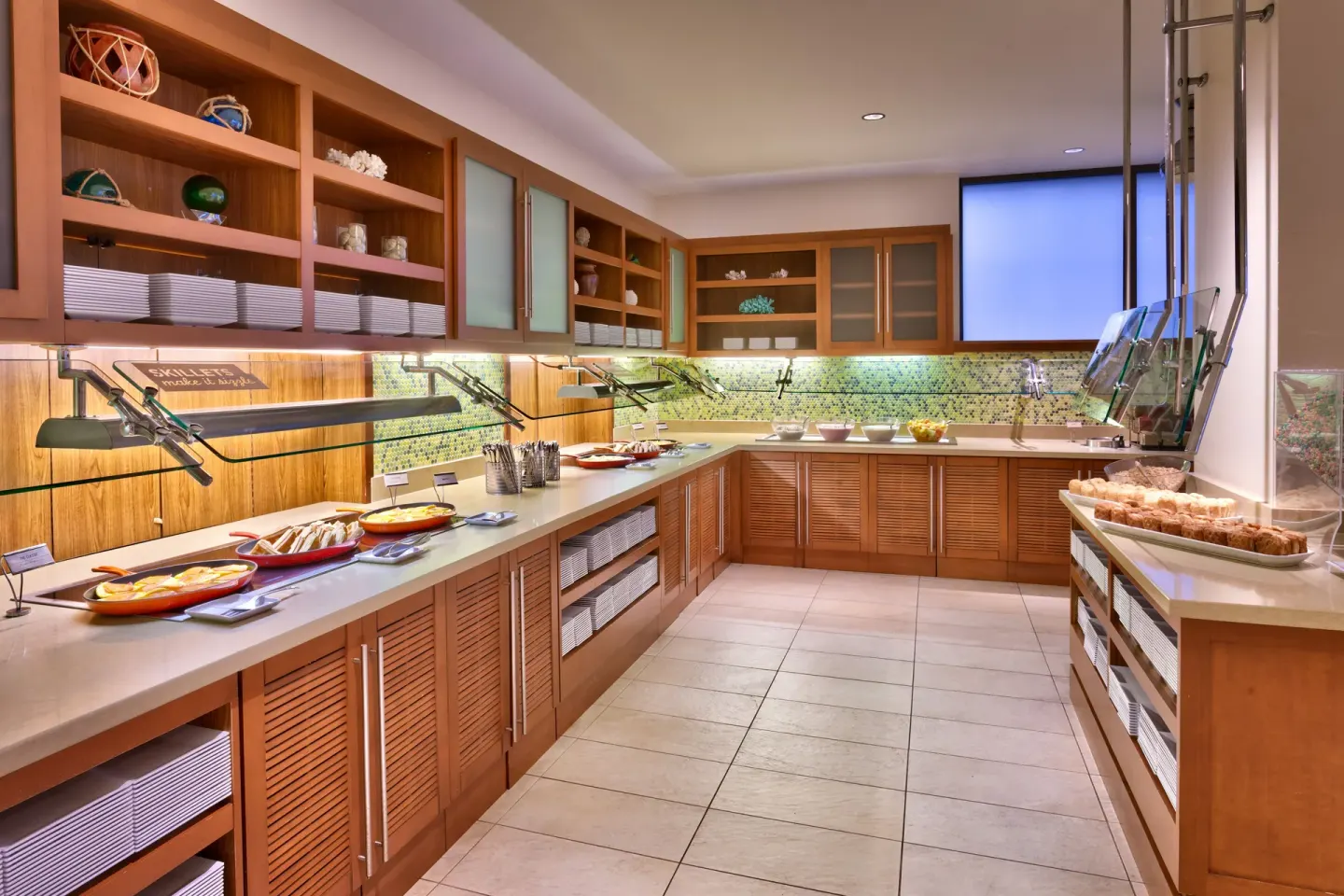 Breakfast buffet line with hot dishes and pastries at Hyatt Place Waikiki Beach.