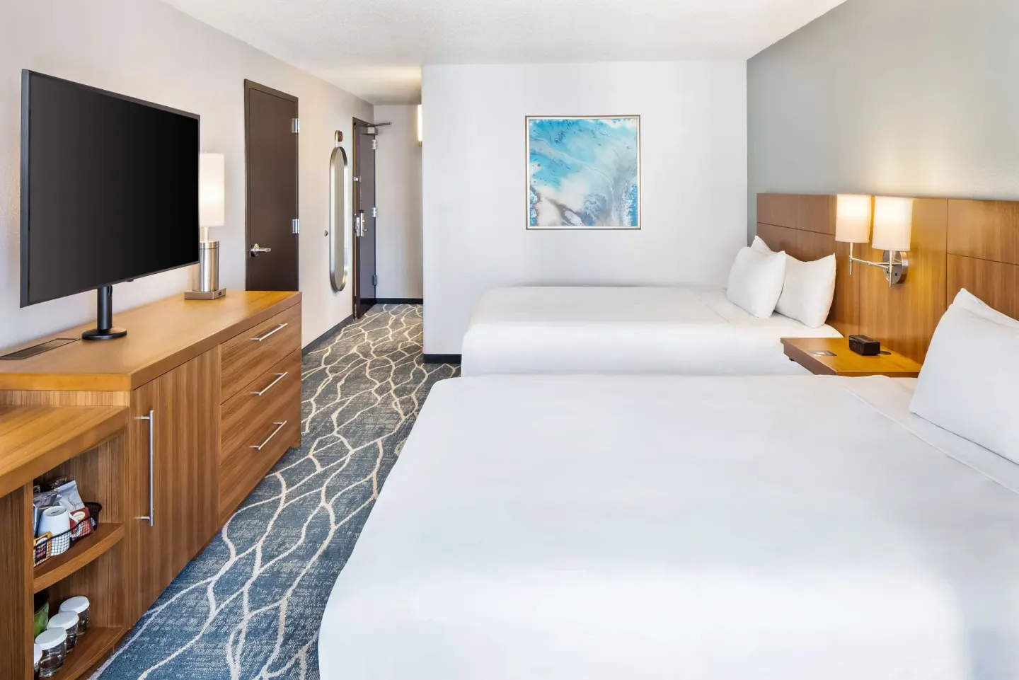 Two queen beds and TV dresser in an ocean view room at Hyatt Place Waikiki Beach.