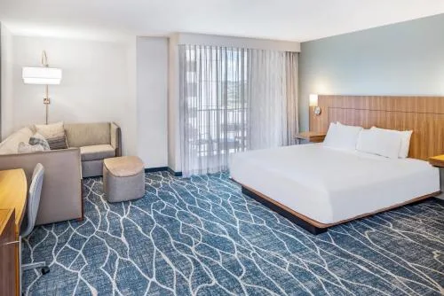Accessible guest room with king bed, sofa bed, and balcony curtains at Hyatt Place Waikiki Beach.
